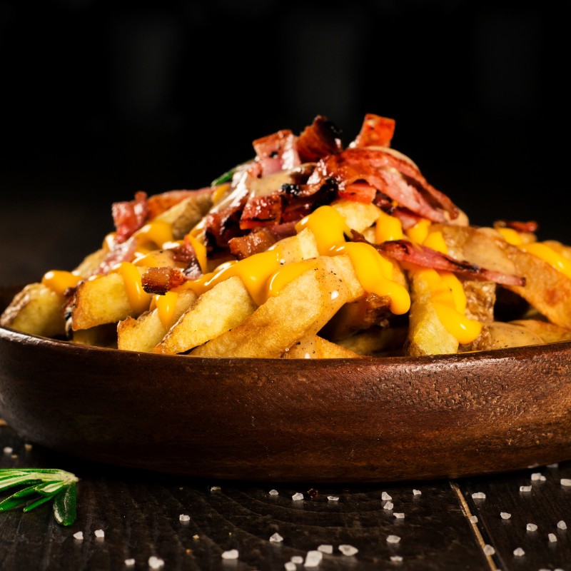 Papas Cascos con Cheddar y Tocineta (Porción Individual)